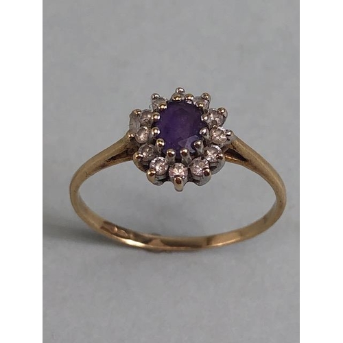 77 - 9ct gold ring set with a central amethyst surrounded by diamonds approximately size N and 1.2g