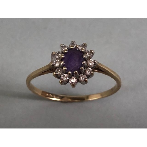 77 - 9ct gold ring set with a central amethyst surrounded by diamonds approximately size N and 1.2g