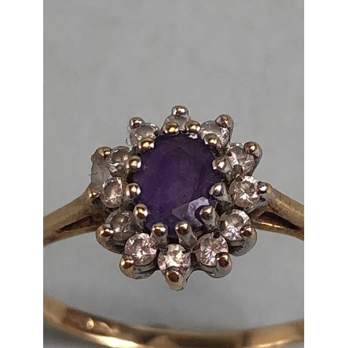 77 - 9ct gold ring set with a central amethyst surrounded by diamonds approximately size N and 1.2g