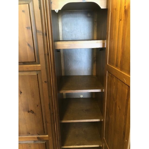 109 - Pine three Door wardrobe with shelves and hanging rail