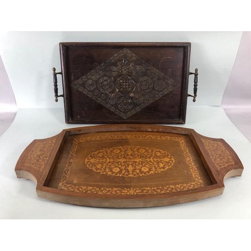 136 - Two wooden trays one 19th century dark oak with geometric carving the other teak with marquetery inl... 