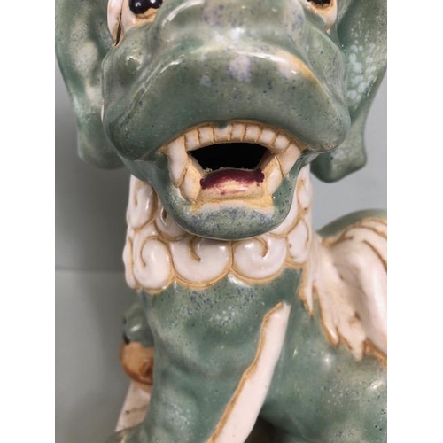 138 - Oriental Ceramics, Two Chinese pottery Foo or Shi Shi dogs glazed in celadon and cream each  approxi... 