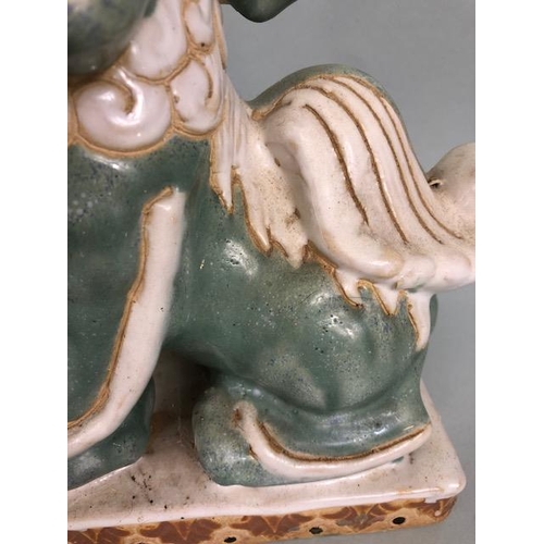 138 - Oriental Ceramics, Two Chinese pottery Foo or Shi Shi dogs glazed in celadon and cream each  approxi... 