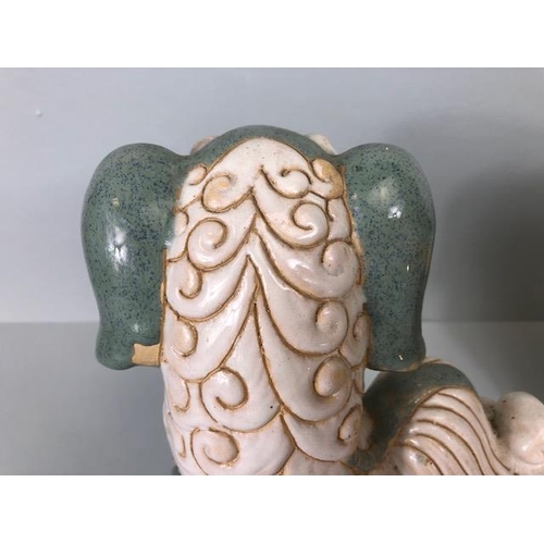 138 - Oriental Ceramics, Two Chinese pottery Foo or Shi Shi dogs glazed in celadon and cream each  approxi... 