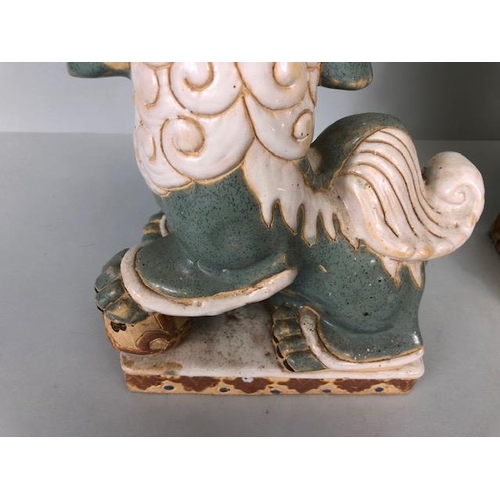 138 - Oriental Ceramics, Two Chinese pottery Foo or Shi Shi dogs glazed in celadon and cream each  approxi... 