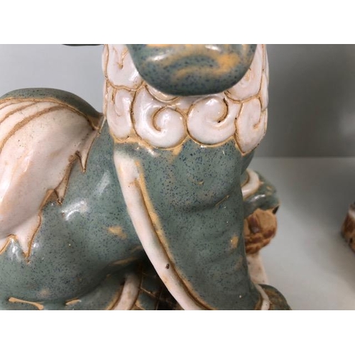 138 - Oriental Ceramics, Two Chinese pottery Foo or Shi Shi dogs glazed in celadon and cream each  approxi... 