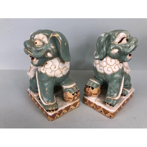 138 - Oriental Ceramics, Two Chinese pottery Foo or Shi Shi dogs glazed in celadon and cream each  approxi... 