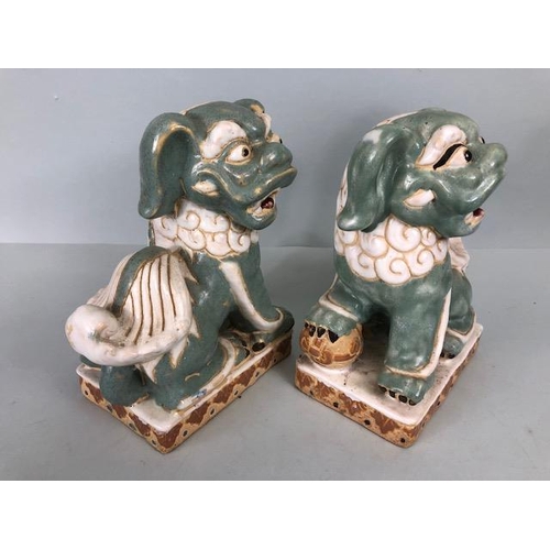 138 - Oriental Ceramics, Two Chinese pottery Foo or Shi Shi dogs glazed in celadon and cream each  approxi... 