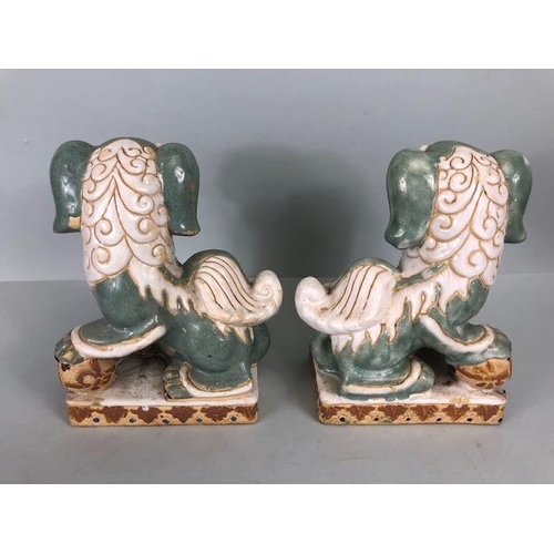 138 - Oriental Ceramics, Two Chinese pottery Foo or Shi Shi dogs glazed in celadon and cream each  approxi... 