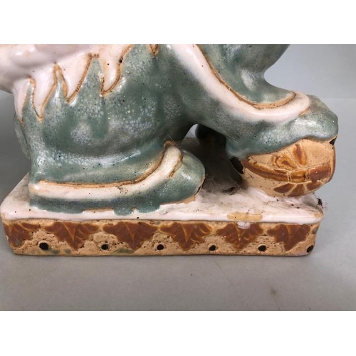 138 - Oriental Ceramics, Two Chinese pottery Foo or Shi Shi dogs glazed in celadon and cream each  approxi... 