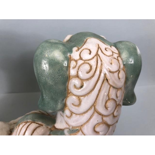 138 - Oriental Ceramics, Two Chinese pottery Foo or Shi Shi dogs glazed in celadon and cream each  approxi... 