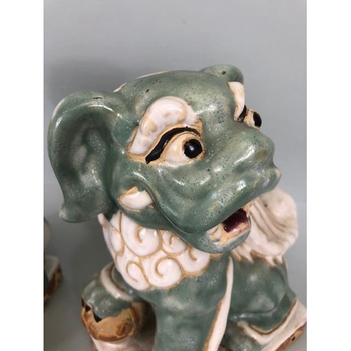 138 - Oriental Ceramics, Two Chinese pottery Foo or Shi Shi dogs glazed in celadon and cream each  approxi... 