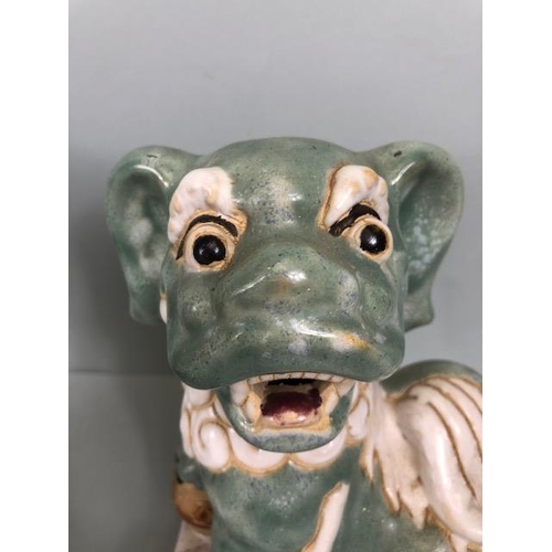 138 - Oriental Ceramics, Two Chinese pottery Foo or Shi Shi dogs glazed in celadon and cream each  approxi... 