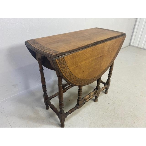 192 - Oak drop leaf table with carved edgework