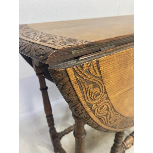 192 - Oak drop leaf table with carved edgework