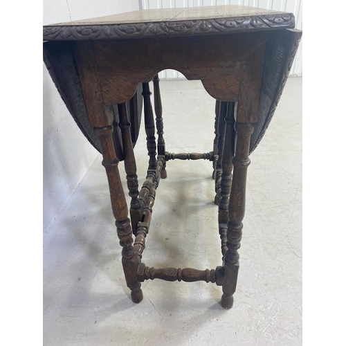 192 - Oak drop leaf table with carved edgework