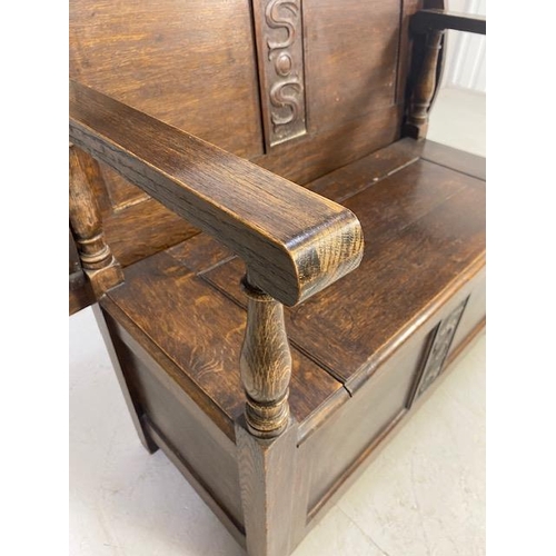 237 - Oak monks bench with sliding table top initials SS carved to back and front approximately 94 x 50 x ... 