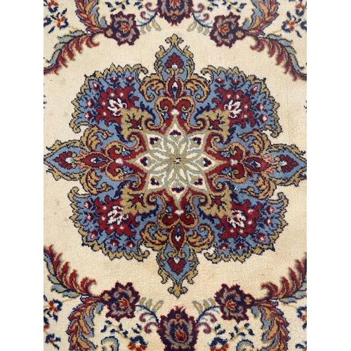 250 - Large rug of Eastern Oriental design, cream back ground with predominantly  blue, red patterns  appr... 