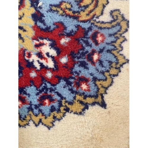 250 - Large rug of Eastern Oriental design, cream back ground with predominantly  blue, red patterns  appr... 