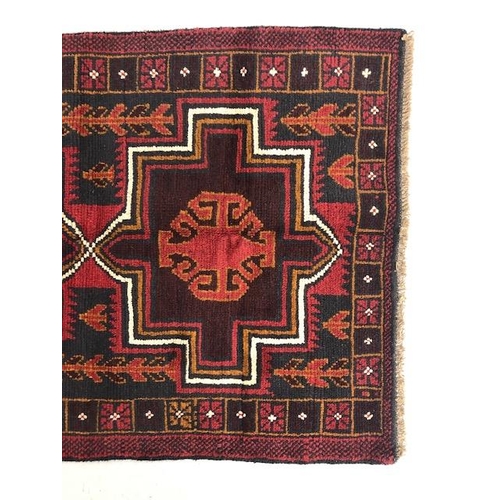 273 - Oriental hand knotted wool carpet Baluchi geometric patterns on a dark burgundy background approxima... 