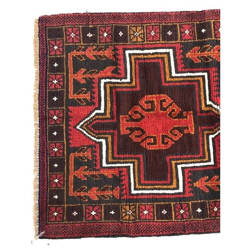 273 - Oriental hand knotted wool carpet Baluchi geometric patterns on a dark burgundy background approxima... 