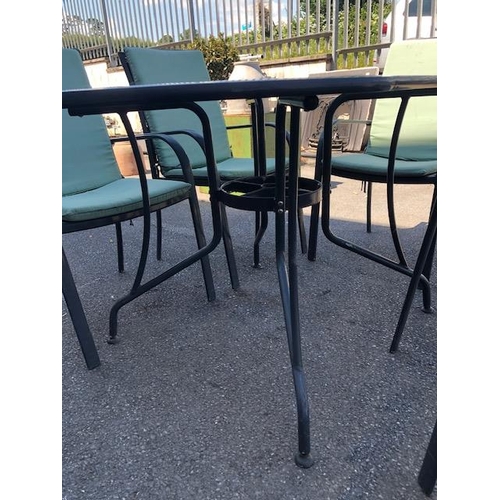 277 - Metal garden table and six chairs with cushions