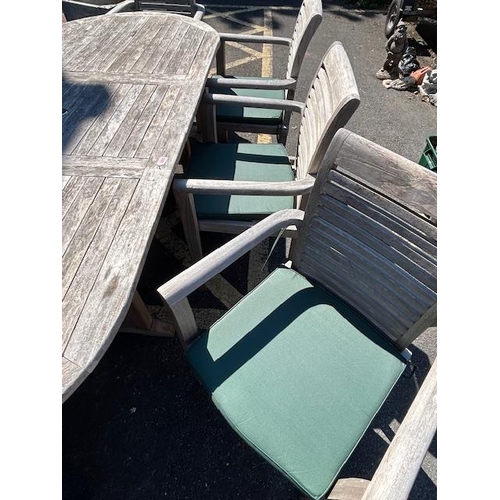 280 - Large Teak Garden table approx 2m x 1m with eight Garden chairs plus cushions