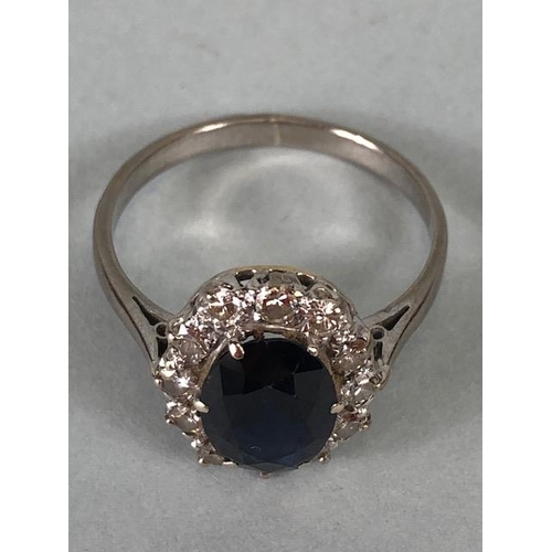 43 - 18ct white gold cluster ring of an oval cut sapphire surrounded with 12 diamonds, approximately 3.6g... 