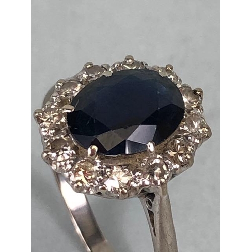 43 - 18ct white gold cluster ring of an oval cut sapphire surrounded with 12 diamonds, approximately 3.6g... 