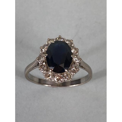 43 - 18ct white gold cluster ring of an oval cut sapphire surrounded with 12 diamonds, approximately 3.6g... 