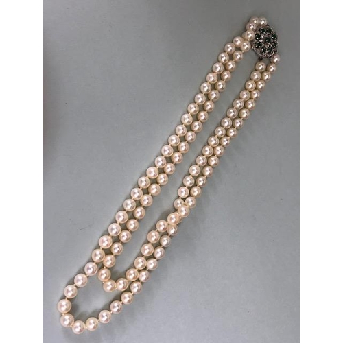 47 - Cultured Pearls double strand joined by an ornate white metal clasp set with gemstones including Dia... 