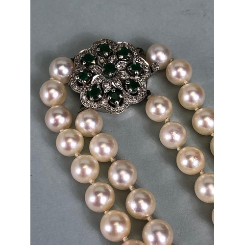 47 - Cultured Pearls double strand joined by an ornate white metal clasp set with gemstones including Dia... 