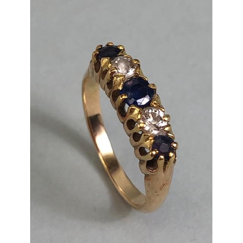 62 - 15ct marked yellow gold ring set with 3 sapphires and 2 diamonds, approximately size K  and 2.7g