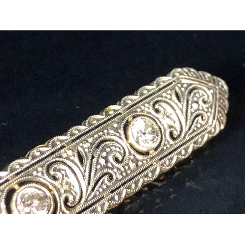 64 - Antique continental  unmarked yellow and white metal bar brooch of scroll nouveau design set with 3 ... 