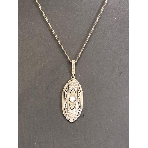 65 - Antique continental yellow and white metal pendant of nouveau scroll design with central round cut d... 