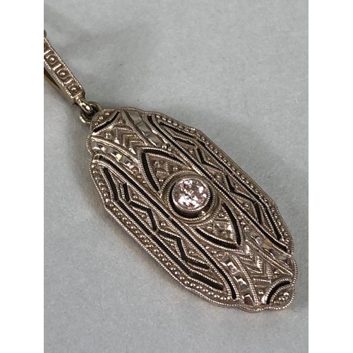 65 - Antique continental yellow and white metal pendant of nouveau scroll design with central round cut d... 