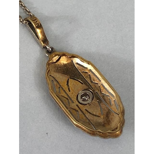 65 - Antique continental yellow and white metal pendant of nouveau scroll design with central round cut d... 