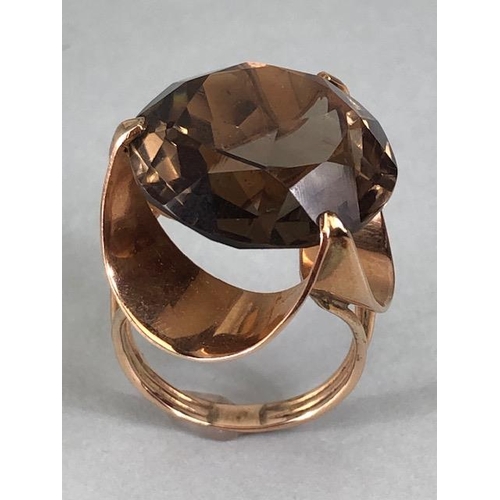 67 - 14kt stamped continental rose gold ring, set with a large round  smoky quartz approximately 10.3g to... 