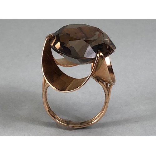 67 - 14kt stamped continental rose gold ring, set with a large round  smoky quartz approximately 10.3g to... 