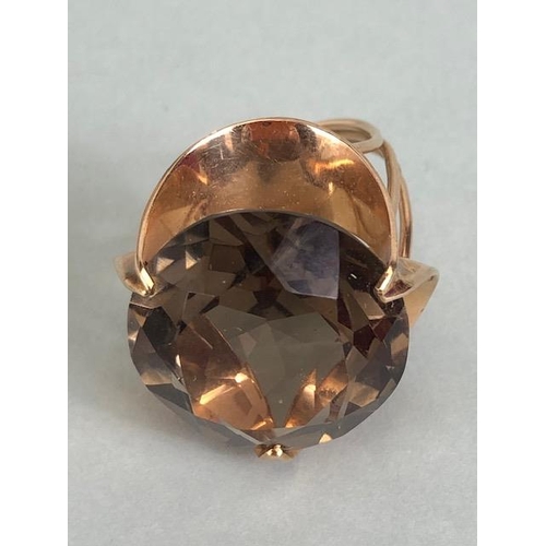 67 - 14kt stamped continental rose gold ring, set with a large round  smoky quartz approximately 10.3g to... 