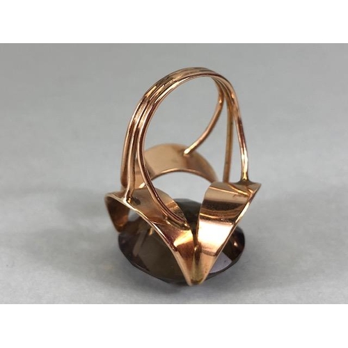 67 - 14kt stamped continental rose gold ring, set with a large round  smoky quartz approximately 10.3g to... 