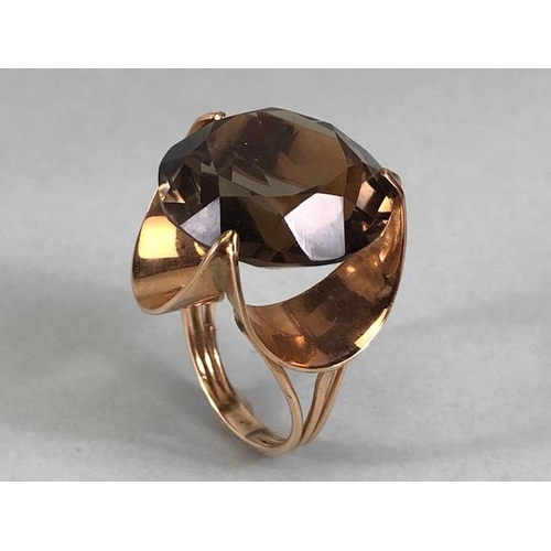 67 - 14kt stamped continental rose gold ring, set with a large round  smoky quartz approximately 10.3g to... 