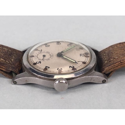 106 - Military watches, WW2 British military wrist watch, round un marked dial with Arabic numerals inset ... 