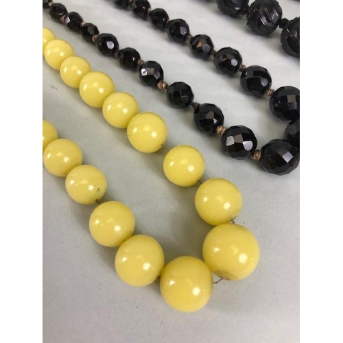 125 - Costume jewellery, 2 sets of antique  black mourning beads and a string of  antique pale Lemon agate... 