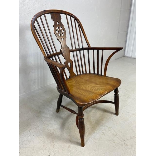 126 - Windsor wheelback and spindle armchair with curved stretcher