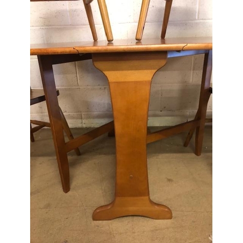 131 - Teak mid century style drop leaf table and four pine chairs