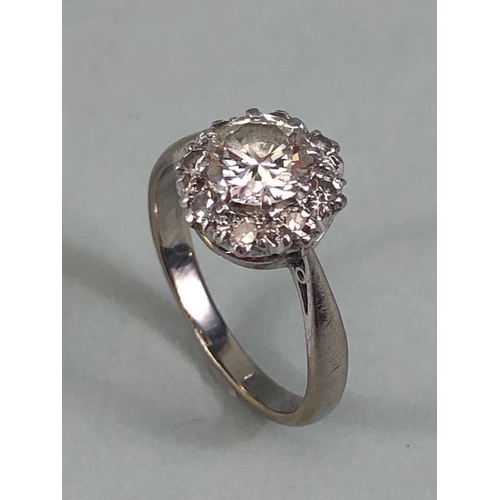 15 - 18ct White Gold daisy style ring set with a central diamond of approx 1ct and surrounded by eight cl... 