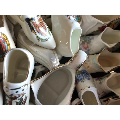 158 - Collectable ceramics, quantity of china  boots and shoes from various makers, to include some town a... 