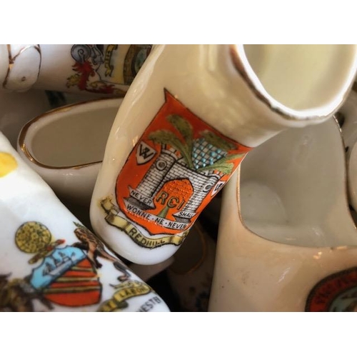 158 - Collectable ceramics, quantity of china  boots and shoes from various makers, to include some town a... 