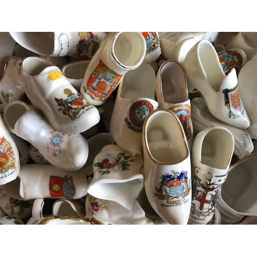 158 - Collectable ceramics, quantity of china  boots and shoes from various makers, to include some town a... 